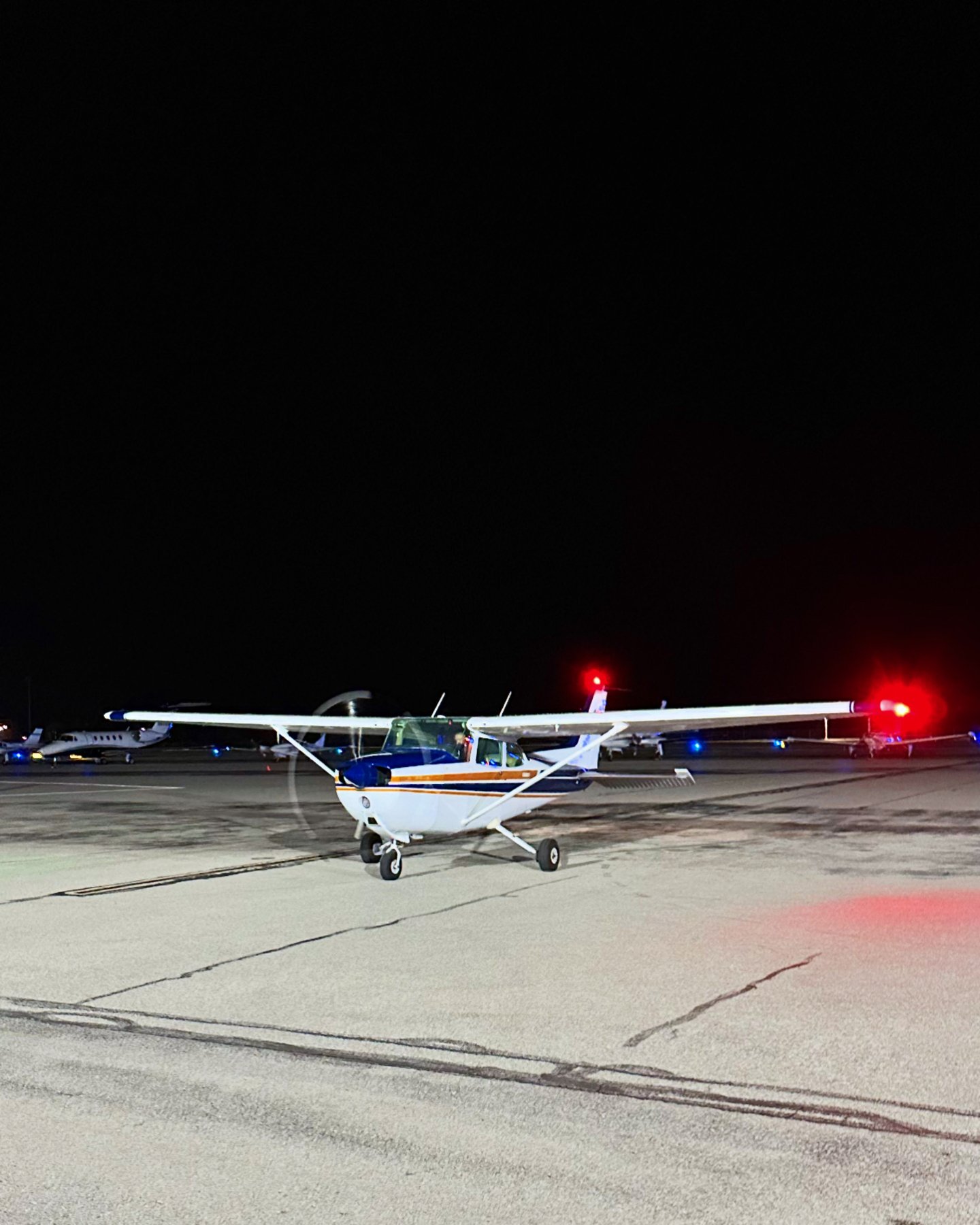 N9862J on the ramp at night with its lights illuminated