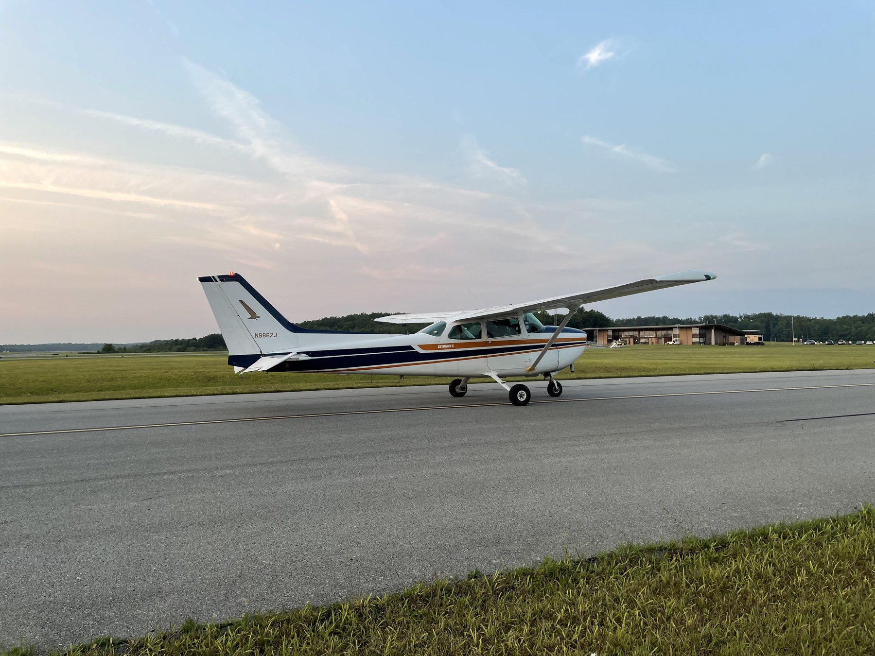 Club-owned Cessna N9862J on the taxiway beneath an evening sky