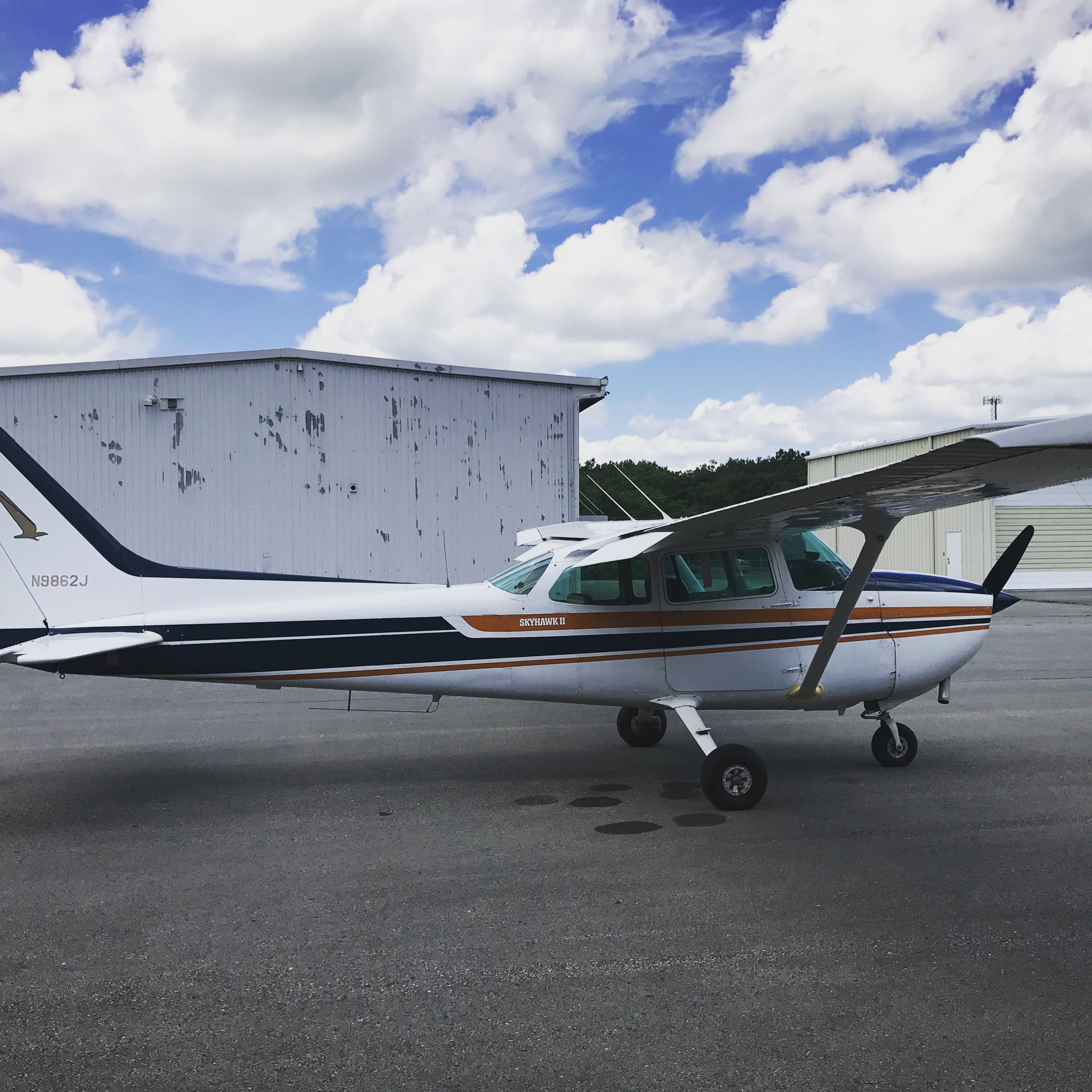 N9862J parked beside the airport hangars