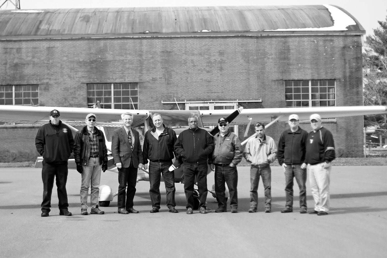 Club members gathered in front of the airplane